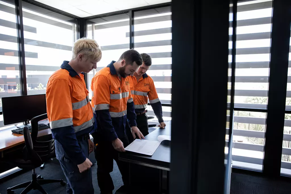 our industrial electricians looking over plans